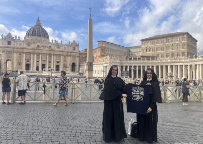 Sisters MICM hold the commemorative 50years tshirt in front of Saint Peter's Basilica!