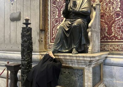 Sister MICM put her head under the foot of Saint Peter.